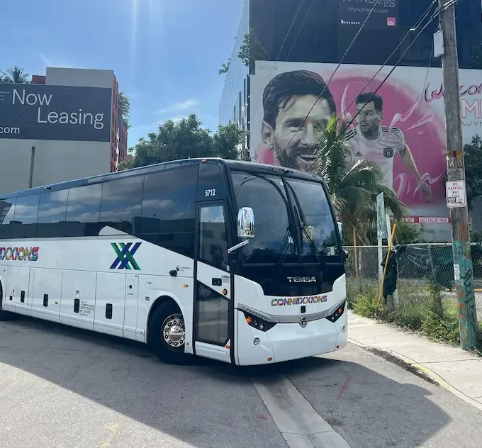 Connexxions charter bus in Miami Wynwood with Lionel Messi mural in the background