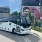 Connexxions charter bus in Miami Wynwood with Lionel Messi mural in the background